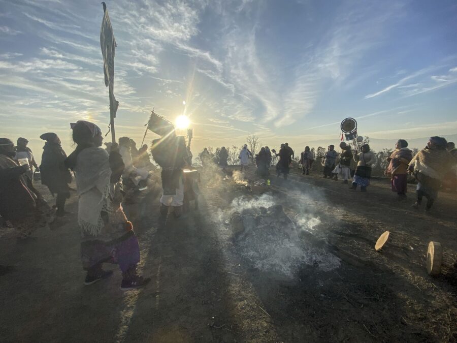 Danzantes y estandartes a contraluz durante el amanecer